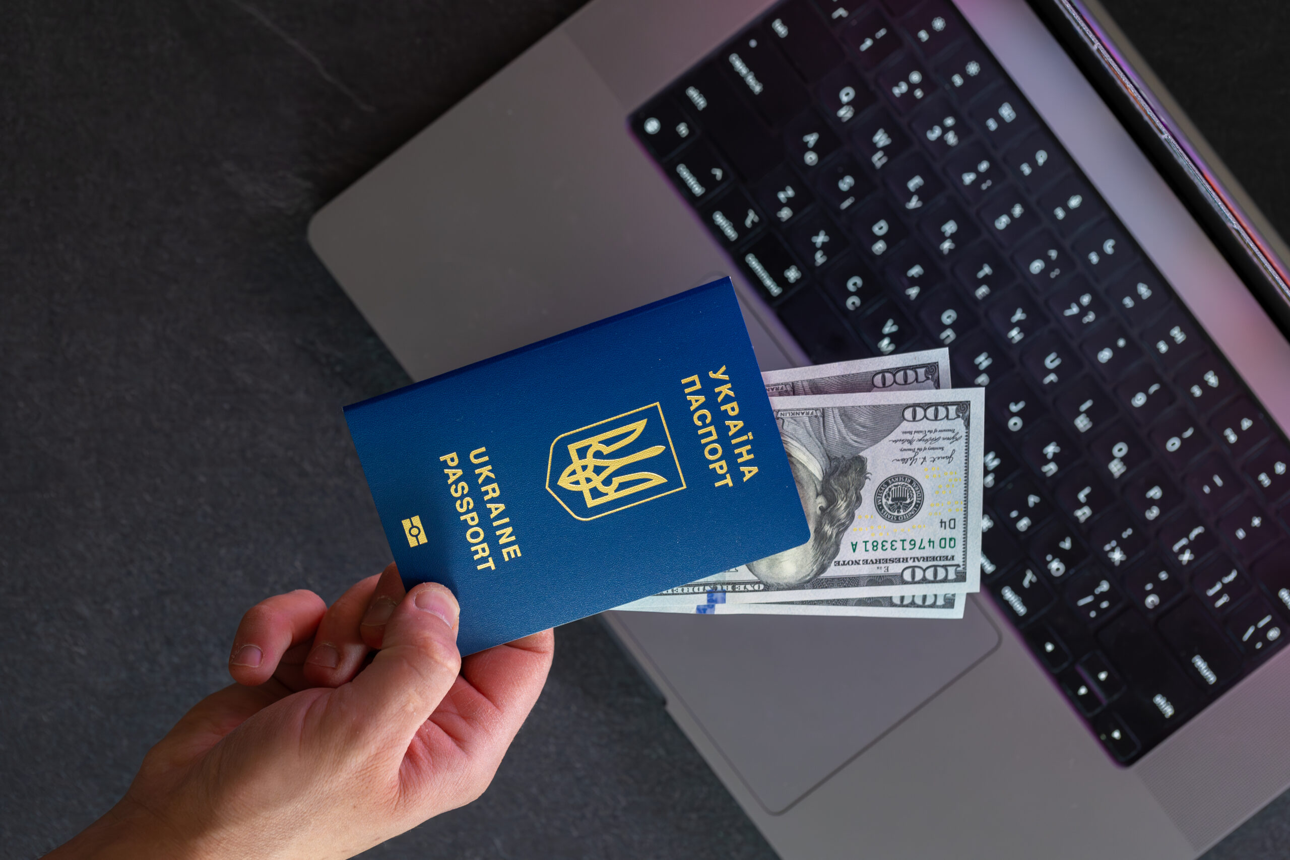 Ukrainian passport. Online visa or immigration for citizens of Ukraine. Travel concept. High quality photo. Traveler getting ready for a trip. Online registration for Ukrainians. Top view.